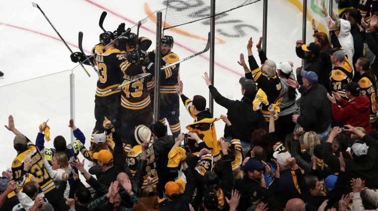 Bruins fans celebrate after a goal by Sean Kuraly, 52, in the third period Tuesday night against the Maple Leafs. Boston won Game 7, 5-1, to advance to the second round against Columbus.