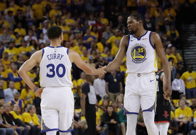 Associated Press/Jeff Chiu
Stephen Curry and Kevin Durant of the Golden State Warriors celebrate Sunday during the 104-100 victory over the Houston Rockets in Game 1.