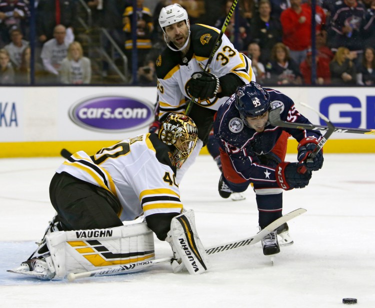 Bruins goalie Tuukka Rask, makes a save against Columbus' Matt Duchene as Zdeno Chara trails the play in the second period.