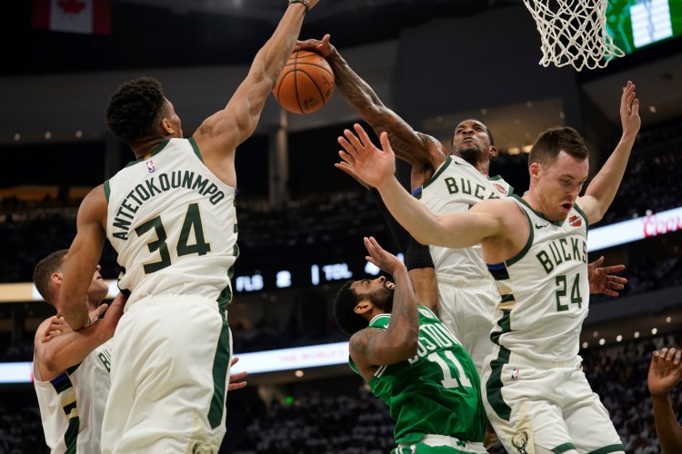 Boston's Kyrie Irving tries to shoot in traffic during the second half of Game 2 of their Eastern Conference semifinal series against the Bucks on Tuesday night in Milwaukee. The Bucks won 123-102 to even the series.