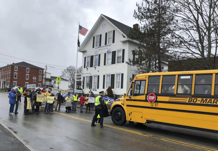 Protesters block a bus transporting guests headed to Bath Iron Works for a christening ceremony of a Zumwalt-class guided missile destroyer named for former President Lyndon Baines Johnson.  Associated Press/David Sharp