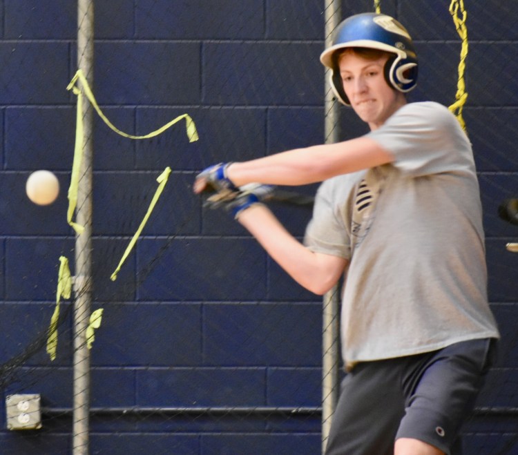 A Mt. Blue player takes a swipe at the baseball in the batting cages. (Franklin Journal photo by Tony Blasi)