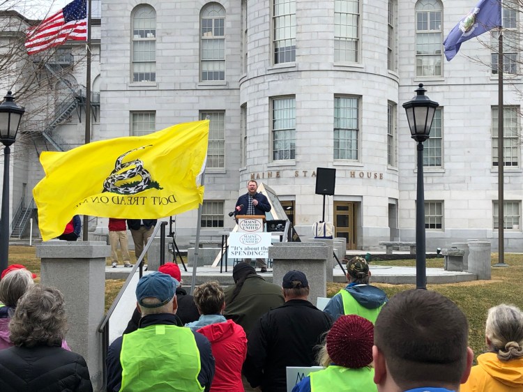 Jacob Posik, communications director for the Maine Heritage Policy Center, a right-leaning think tank that advocates for tax cuts, speaks to a crowd of about 60 at a rally against taxes at the State House on Monday – the day state and federal income taxes were due in most of the U.S.
