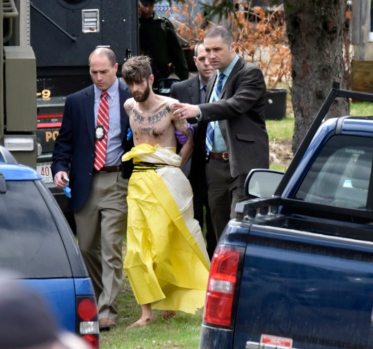 John D. Williams is led by Maine State Police detectives into a cruiser after he was apprehended April 28, 2018, in Fairfield. 