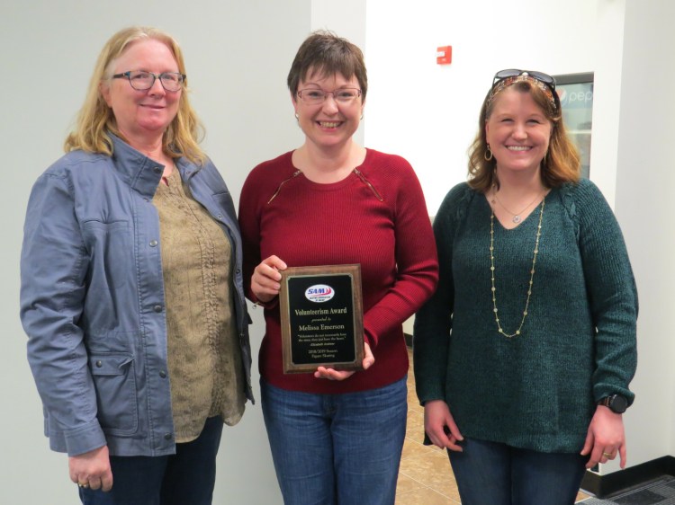 Sue Smith, board president, and Dawn Kilgore, chairwoman of the figure skating committee, right, presented Melissa Emerson, from Manchester with the SAM figure skating Volunteerism Award at the annual meeting at the Camden National Bank Ice Vault in Hallowell.