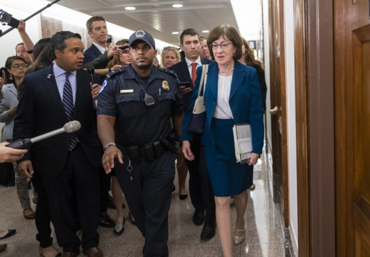 Sen. Susan Collins, R-Maine, is escorted by U.S. Capitol Police in October 2018 in Washington during the fight over the appointment of Brett Kavanaugh to the U.S. Supreme Court. A Maine woman is facing federal charges of mailing a threatening letter to Collins' home last year.
