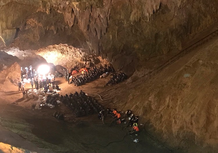 Emergency rescue teams gather in the staging area as they continue the search for 12 young soccer team members and their coach after going missing in a large cave in Thailand in 2018.