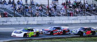 Nick HInkley (15) of Wiscasset leads Nick Reno (77) of West Bath and Kevin Douglass (18) of Sidney during a Pro Stock feature last season at Wiscasset Speedway in Wiscasset. Hinkley and Douglass finished 1-2 in the final point standings.