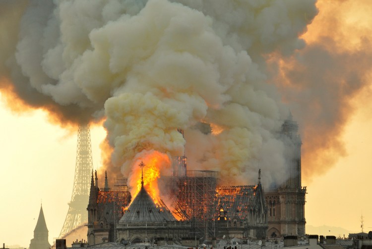 Flames and smoke rise from the blaze at Notre Dame cathedral in Paris on Monday.