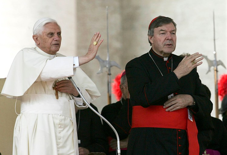 Pope Benedict XVI, left, and Cardinal George Pell bless the faithful during the weekly general audience in St. Peter's square at the Vatican in 2005. Cardinal George Pell was sentenced in an Australian court on Wednesday, March 13, 2019 to 6 years in prison for molesting two choirboys in a Melbourne cathedral more than 20 years ago.  