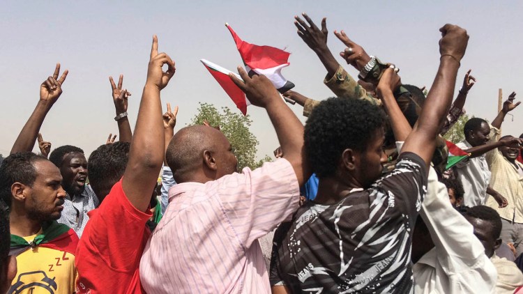 Sudanese celebrate after officials said the military had forced longtime autocratic President Omar al-Bashir to step down after 30 years in power in Khartoum on Thursday.