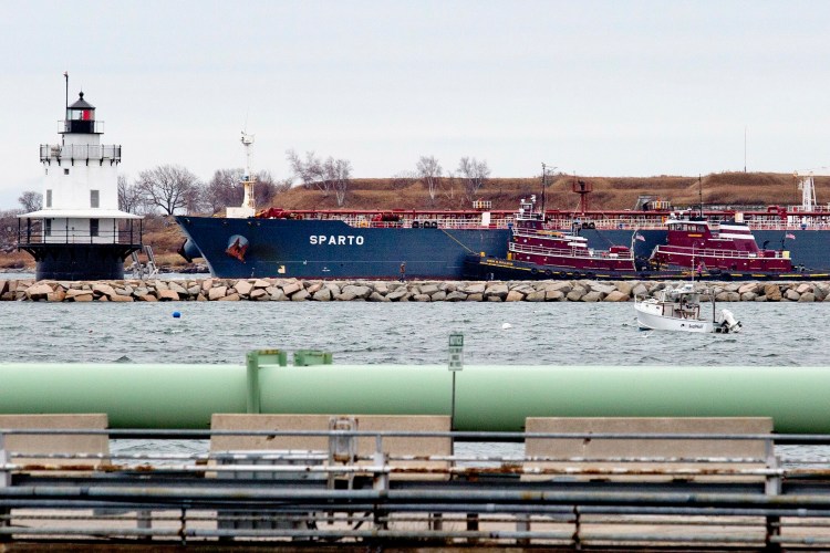 The oil tanker Sparto makes its way past Spring Point Ledge Lighthouse with the help of tugboats in November 2015. Fewer barges today means less money for the harbor pilots who guide large vessels through the harbor. The pilots received an increase in their fees this week.