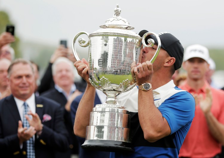 Brooks Koepka kisses the Wanamaker trophy after winning the PGA Championship on Sunday, at Bethpage Black in Farmingdale, N.Y. 