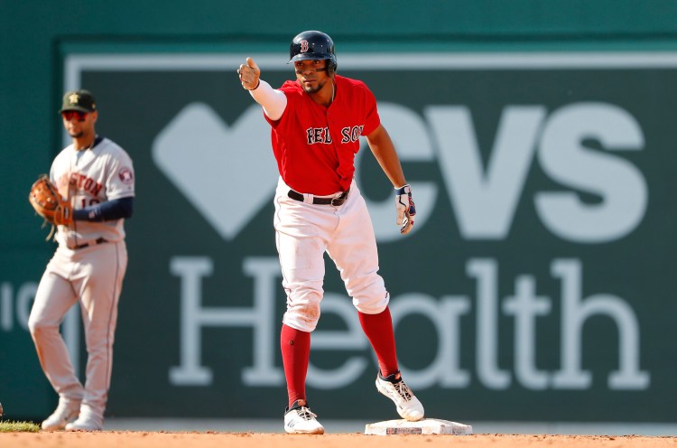 Xander Bogaerts signals toward the dugout after an RBI double in the Red Sox' 4-3 win over the Houston Astros on Sunday in Boston.