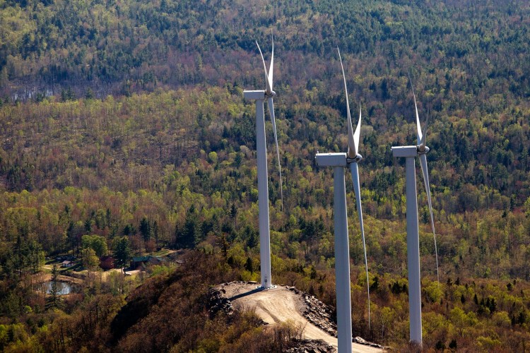 Three wind turbines stand atop a ridge just south of Webb Lake in this aerial photograph taken in 2015. A bill before lawmakers now would mandate increasing the percentage of electricity delivered to Maine consumers from renewable sources. 