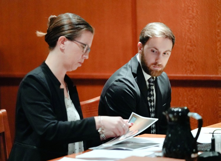 Mark Cardilli Jr. looks as Sarah Churchill, one of his attorneys, gathers photos during his bail hearing at the Cumberland County Courthouse on Tuesday.