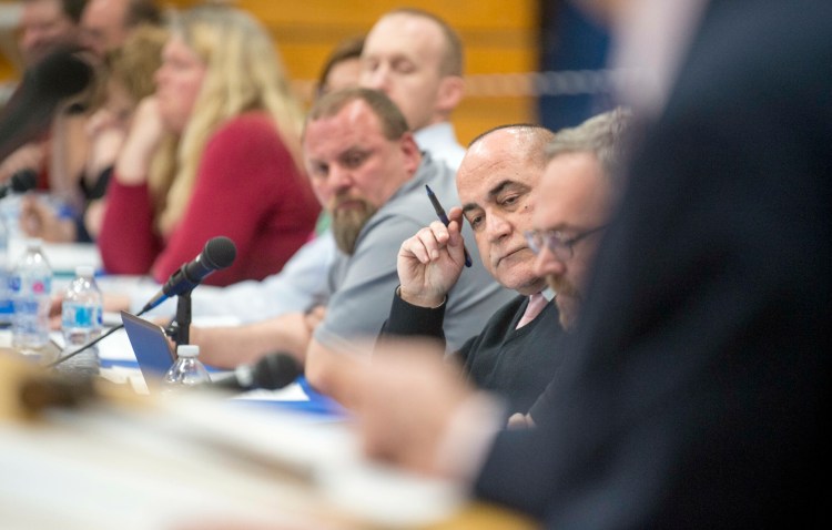 SAD 49 Superintendent Reza Namin, center, holds his finger to his head May 14 during a SAD 49 school budget meeting at Lawrence Junior High School in Fairfield.