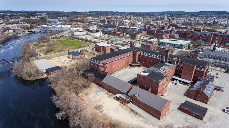 The Continental Mill beside the Androscoggin River in Lewiston, shown in 2019, is the focus of redevelopment efforts. The city has hired a consultant to update a plan to redevelop the riverfront area, including the canal system, the riverfront trail, and Simard-Payne and Veterans Memorial parks.