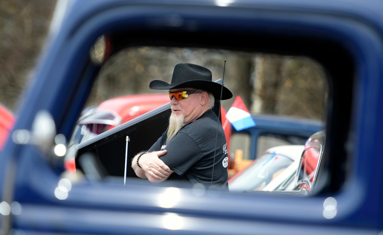 Walter Willey of Fairfield Center inspects cars on display Sunday during the cruise at the CARA fields. A fundraiser was held to replace a building at the complex destroyed by fire.