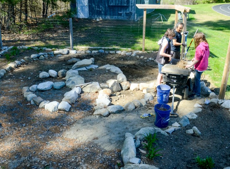 From left: Leah Southworth, Naoto Kobayashi and Lily Hall work in the garden on May 9 at Hall-Dale Middle and High School in Farmingdale.