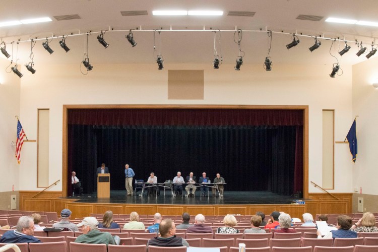 People gather Tuesday for the Oakland Town Meeting at the performing arts center at Messalonskee High School.