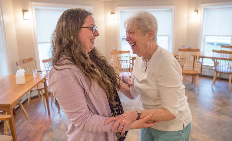 Abbie Hartford receives a hug and thanks from Nancy Barnes after morning exercises at the Pierce House in Farmington on Friday. The UMF graduating senior started UMF Senior Buddies to address the issue of loneliness among the elderly and to get students to visit them in group homes.
