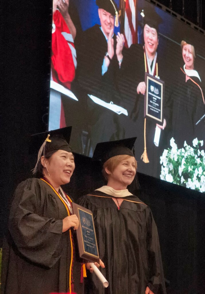 Lion Oyerbides, left, received the Kathleen Dexter Distinguished Student Award from Dean of Students Sheri Fraser on Saturday during the University of Maine at Augusta commencement at the Augusta Civic Center. 
