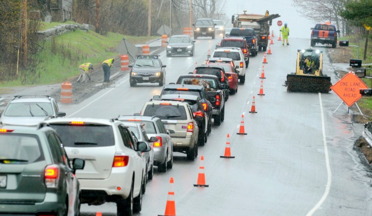 Pavement milling on shoulders of Route 3 continues in the rain Friday in Augusta.