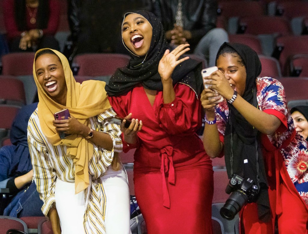 PORTLAND, ME - MAY 12: Sisters Hamdi Sheikh, Fardowsa Mohamed,and Aisha Mukhtar cheer for their sister Maryan Mukhtar who had just received a degree in Liberal Studies during the Southern Maine Community College commencement at Cross Insurance Arena in Portland on Sunday, May 12, 2019.(Staff Photo by Carl D. Walsh/Staff Photographer)