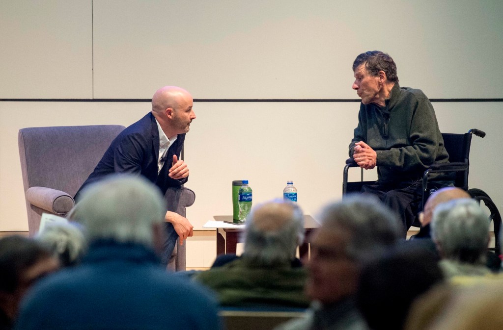 Travis Barrett, left, interviews George Smith, outdoorsman and writer, on Tuesday evening for Community Voices at the Ostrove Auditorium at Colby College in Waterville.