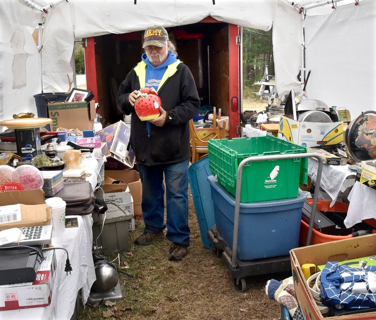 Lawrence Bowley fills a tent Wednesday in Skowhegan with items to sell during this weekend’s 36th annual 10-Mile Yard Sale. Bowley also will sell grilled food to benefit the Unity Area Volunteer Food Pantry.
