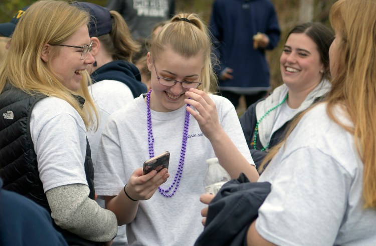 Melayna Benner, center, laughs with teammates from the Medomak Valley High School softball team who attended the Great Strides cystic fibrosis walk with her in Augusta on Sunday.