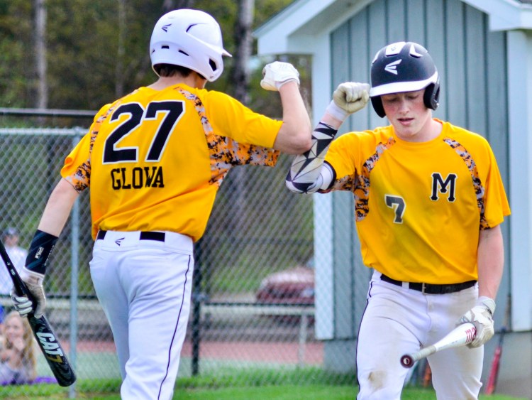 Maranacook's Hunter Glowa celebrates with teammate Duncan Rogers after Rogers scored a run to put the Black Bears up 1-0 in the first inning against Waterville on Wednesday in Readfield. 
