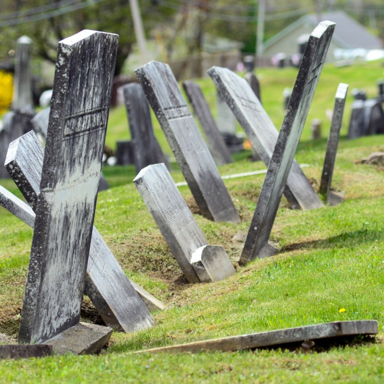Leaning and fallen grave stones are seen Thursday in Maple Cemetery in Winthrop.