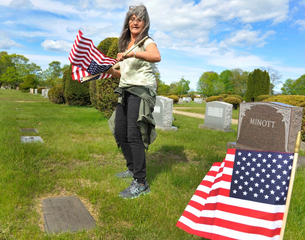 SOUTH PORTLAND, MAINE - MAY 22, 2019:   
VFW club members and volunteers place small American flag's on the grave sites of veterans at the Forest City cemetary in South Portland. Margaret Russo, president of the women's auxilary at Portland's VFW Post 161 in Portland places flags on the graves of veterans. ( Photo by John Ewing/Staff Photographer)