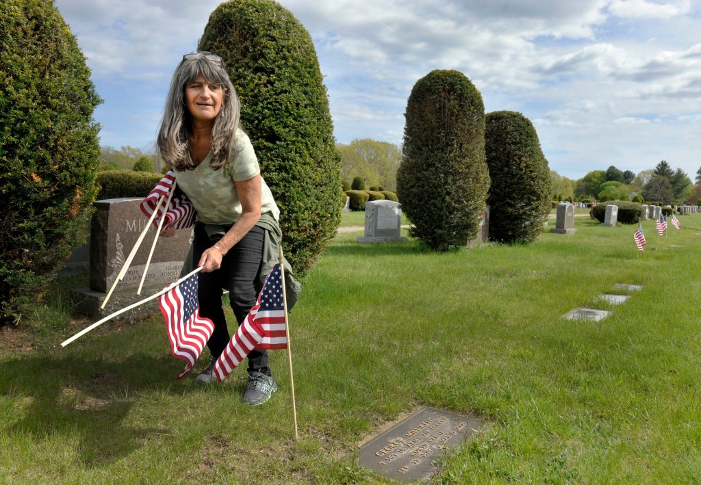 SOUTH PORTLAND, MAINE - MAY 22, 2019:   
VFW club members and volunteers place small American flag's on the grave sites of veterans at the Forest City cemetary in South Portland. Margaret Russo, president of the women's auxilary at Portland's VFW post 161 looks for veteran grave sites. ( Photo by John Ewing/Staff Photographer)