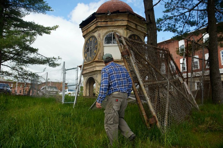 Dan LeBlond, a Biddeford resident and local historian, walks up to the clock tower that once sat atop the Lincoln Mill in Biddeford on  May 24, 2019. LeBlond and a group of locals are trying to raise money to restore the clock tower, that was brought down from the mill in 2007, and put in a public park. 
