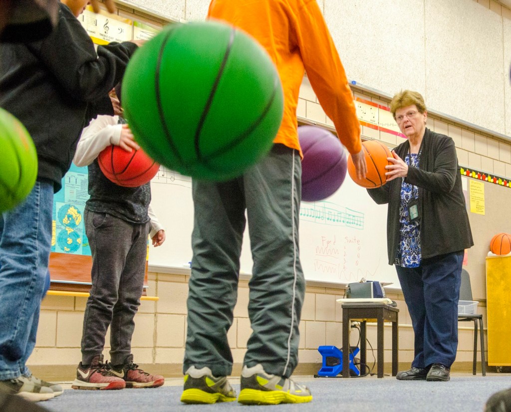 Music teacher Sharon Beaver instructs students Thursday at Farrington Elementary School in Augusta. They were bouncing the balls in tempo with recorded classic music. 