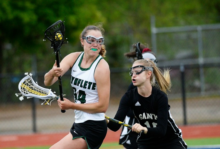 Waynflete's Emi Boedeker looks for an open teammate while being guarded by St. Dom's Isabella Webster in Wednesday's game. Waynflete won 11-2.