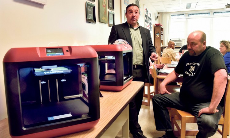 RSU 74 residents approved a revised budget at a district meeting on May 30. Superintendent Mike Tracy, left at a 3-D printer training session for teachers, will meet with residents of Embden, Solon and New Portland this week to address the budget that goes to referendum on June 11.
