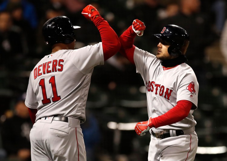 Michael Chavis, right, is greeted by Rafael Devers after hitting a two-run homer Friday night against the Chicago White Sox. Devers also homered – his first of the season – in a 6-1 win.