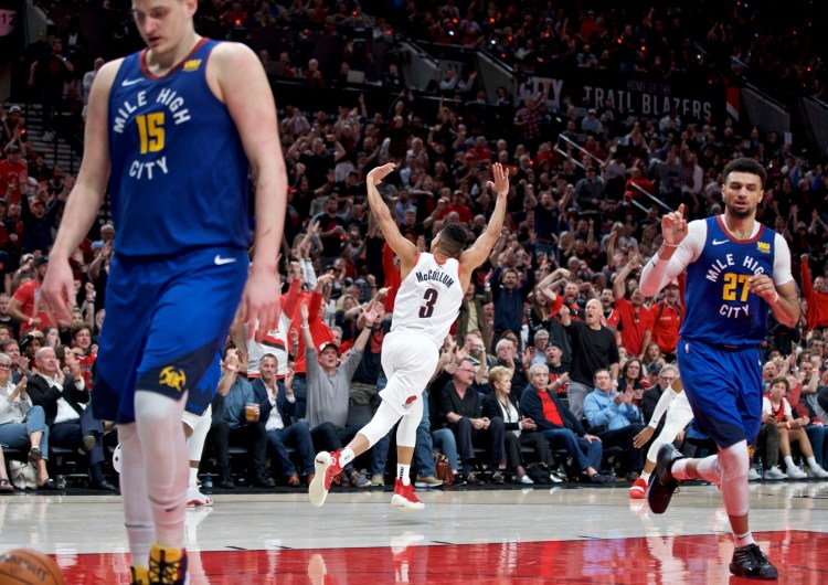 Trail Blazers guard CJ McCollum, center, reacts after making a 3-pointer during the  against the Denver Nuggets during Portland's 140-137 win in four overtimes in Game 3 of their Western Conference semifinal playoff series on Friday in Portland, Ore.