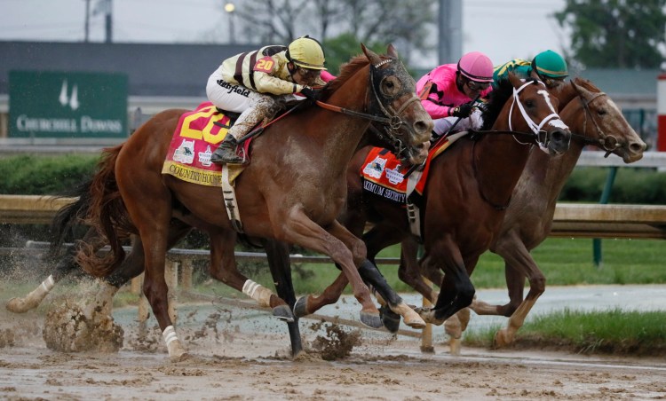 Maximum Security, center, and jockey Luis Saez cross the finish line first ahead of Country House, left, and jockey Flavien Prat, during the 145th running of the Kentucky Derby on Saturday at Churchill Downs, in Louisville, Ky. Country House was declared the winner after Maximum Security was disqualified following a review by race stewards. 