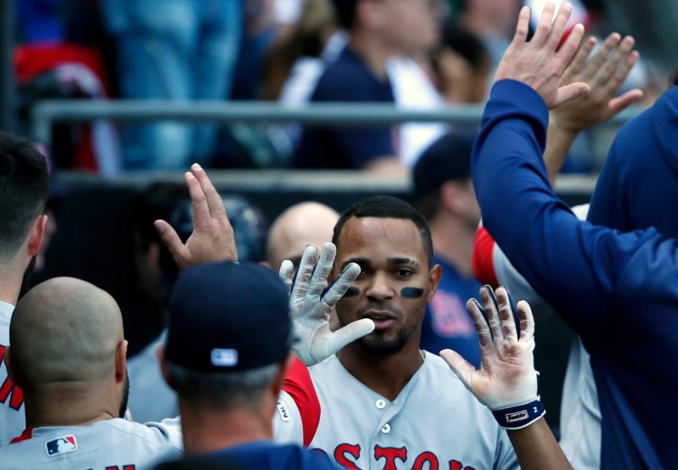 Boston's Xander Bogaerts celebrates with teammates in the dugout after hitting a grand slam in the eighth inning of the Red Sox' 9-2 win over the White Sox on Sunday in Chicago.