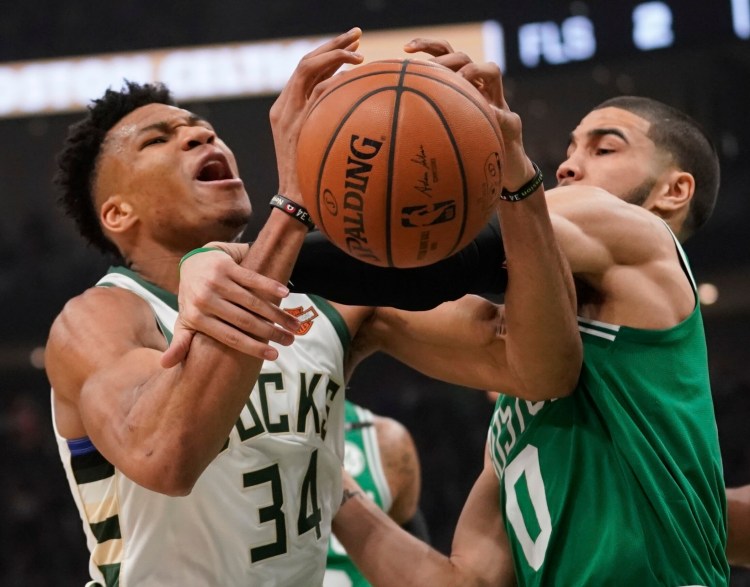 Milwaukee's' Giannis Antetokounmpo is fouled by Boston's Jayson Tatum in the the first half of Game 5 Wednesday night.