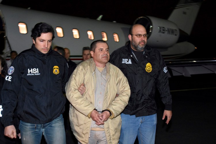 In this Jan. 19, 2017 file photo provided U.S. law enforcement, authorities escort Joaquin "El Chapo" Guzman, center, from a plane to a waiting caravan of SUVs at Long Island MacArthur Airport, in Ronkonkoma, N.Y. 
