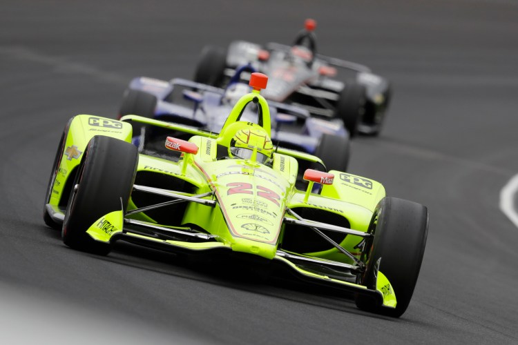 Simon Pagenaud leads a pack through the first turn during the Indy 500 on Sunday at Indianapolis Motor Speedway in Indianapolis. Pagenaud earned his first Indy 500 victory, winning a duel with Alexander Rossi.