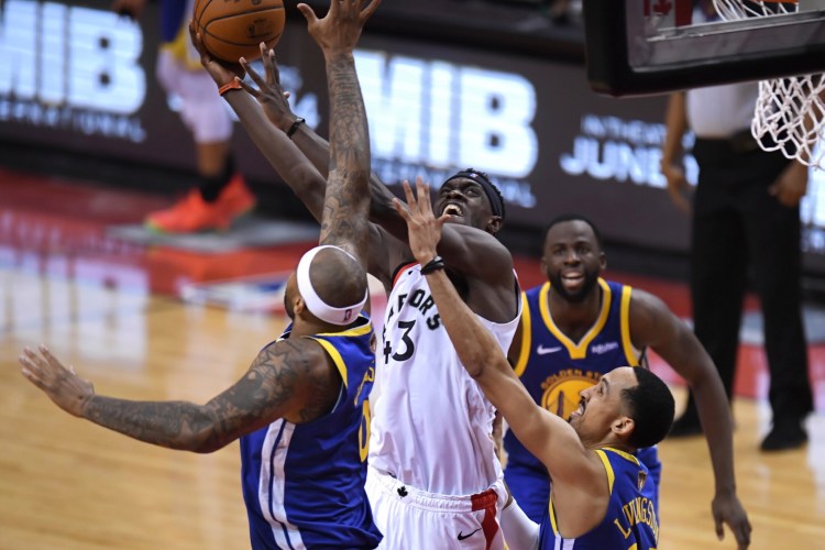 DeMarcus Cousins of the Golden State Warriors, left, will need to play more than eight minites and be more of a factor containing Pascal Siakam and others who came up big for the Toronto Raptors in the opener of the NBA finals.