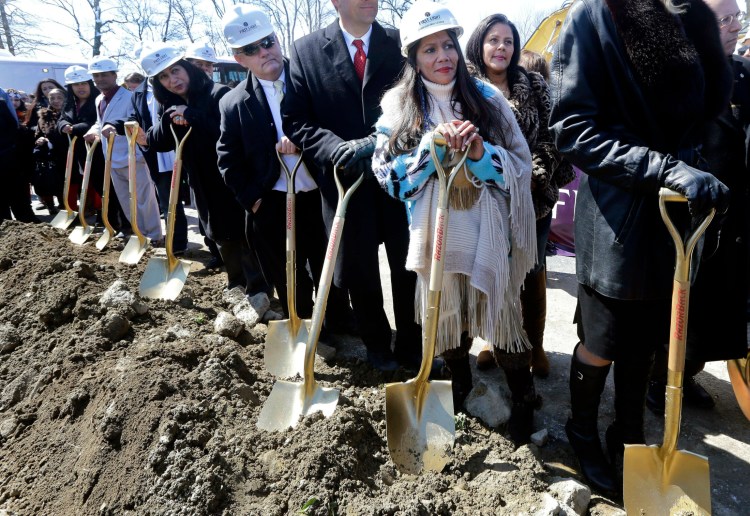 Mashpee Wampanoag Tribal Council member Winnie Johnson Graham, foreground, holds a shovel along with others during an official groundbreaking for a planned a resort casino in Taunton, Mass., on April 5, 2016. The project has yet to be built and has been caught up in political wrangling ever since.
