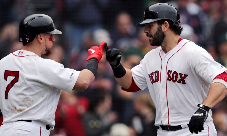 Mitch Moreland, right, celebrates with Christian Vazquez after hitting a solo home run in Boston's 7-3 win over Oakland on Wednesday at Fenway Park.